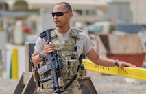 Senior Airman Alexander Hunter, 380th Security Forces, stands guard at a gate Al Dhafra Air Base, United Arab Emirates, May 17, 2018. Air Force security forces members are trained in law enforcement and combat arms to protect and serve their fellow Airmen. (U.S. Air National Guard photo illustration by Staff Sgt. Ross Alexander Whitley)