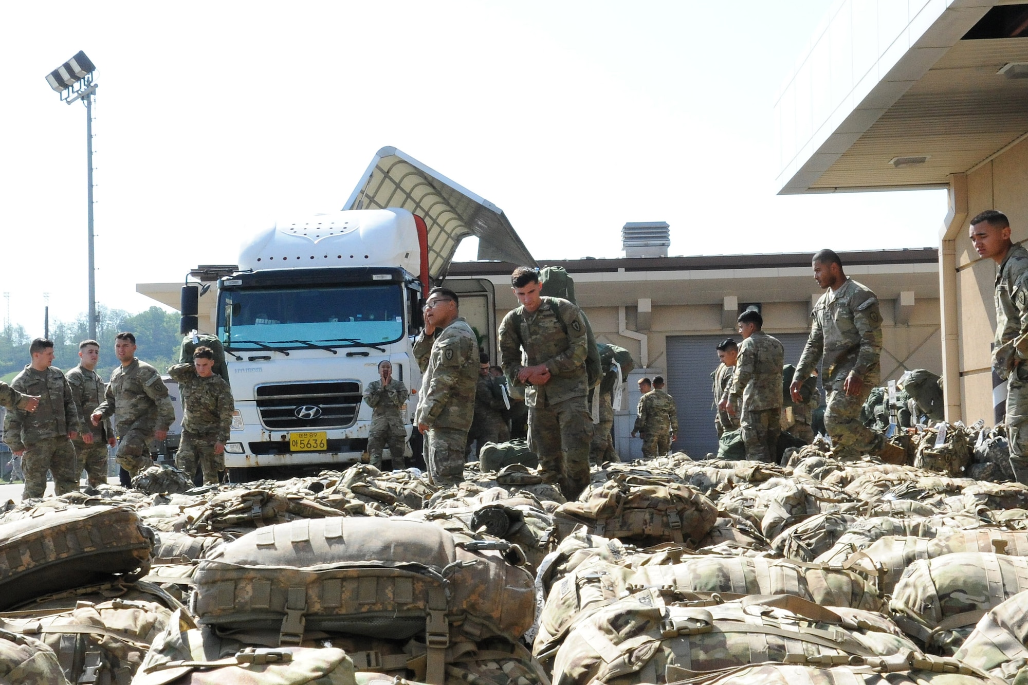 U.S. Army Soldiers with the 1st Battalion, 21st Infantry, 2nd Brigade, 25th Infantry Division unload bags from a truck before loading them onto a Korean Air Boeing 777 aircraft at Osan Air Base, Republic of Korea May 4, 2018. More than 500 U.S. Soldiers from the 25th Infantry Division were transported from Osan Air Base to the Philippines to support exercise Balikatan in support of the Mutual Airlift Support Agreement, which was exercised at Osan Air Base for the first time. (U.S. Air Force photo by Tech. Sgt. Ashley Tyler)