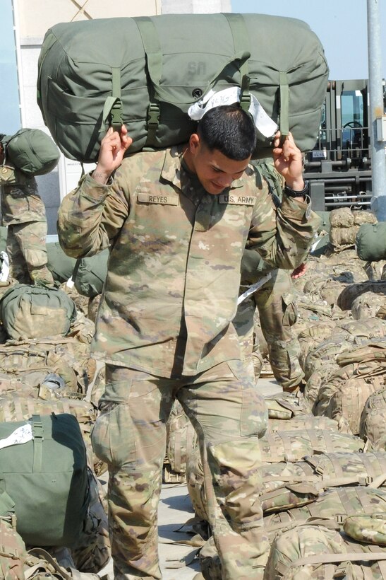 U.S. Army Private Johnathan Reyes, assigned to the 1st Battalion, 21st Infantry, 2nd Brigade, 25th Infantry Division, carries a bag to be sorted before loading onto a Korean Air Boeing 777 aircraft at Osan Air Base, Republic of Korea May 4, 2018. More than 500 U.S. Soldiers participated in a Mutual Airlift Support Agreement exercise to increase airlift capability and flexibility to U.S. Transportation Command during a contingency by using Korean Air aircraft to transport U.S. troops and equipment to forward operating bases in or near the Korean peninsula. (U.S. Air Force photo by Tech. Sgt. Ashley Tyler)