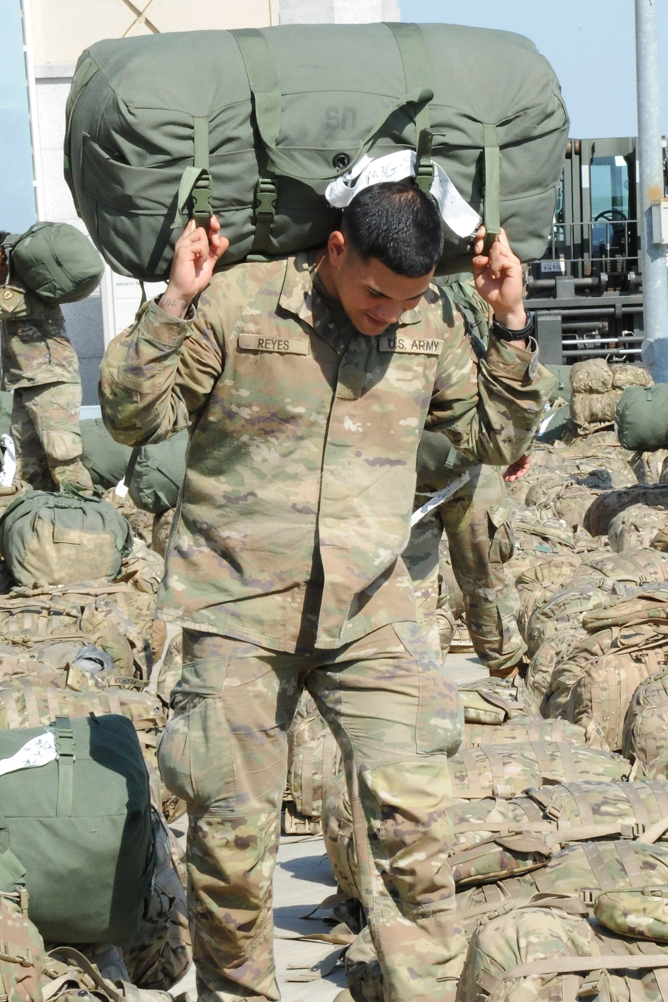 U.S. Army Private Johnathan Reyes, assigned to the 1st Battalion, 21st Infantry, 2nd Brigade, 25th Infantry Division, carries a bag to be sorted before loading onto a Korean Air Boeing 777 aircraft at Osan Air Base, Republic of Korea May 4, 2018. More than 500 U.S. Soldiers participated in a Mutual Airlift Support Agreement exercise to increase airlift capability and flexibility to U.S. Transportation Command during a contingency by using Korean Air aircraft to transport U.S. troops and equipment to forward operating bases in or near the Korean peninsula. (U.S. Air Force photo by Tech. Sgt. Ashley Tyler)