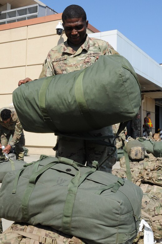 U.S. Army Private 1st Class Kentrell Luckett, assigned to Headquarters, Headquarters Company, 1st Battalion, 21st Infantry, 2nd Brigade, 25th Infantry Division, sorts luggage before loading onto a Korean Air Boeing 777 aircraft at Osan Air Base, Republic of Korea May 4, 2018. More than 500 U.S. Soldiers participated in a Mutual Airlift Support Agreement exercise to increase airlift capability and flexibility to U.S. Transportation Command during a contingency by using Korean Air aircraft to transport U.S. troops and equipment to forward operating bases in or near the Korean peninsula. (U.S. Air Force photo by Tech. Sgt. Ashley Tyler)