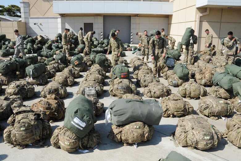 U.S. Army Soldiers with the 1st Battalion, 21st Infantry, 2nd Brigade, 25th Infantry Division unload bags from a truck before loading them onto a Korean Air Boeing 777 aircraft at Osan Air Base, Republic of Korea May 4, 2018. More than 500 U.S. Soldiers were transported from Osan Air Base to the Philippines to support exercise Balikatan. (U.S. Air Force photo by Tech. Sgt. Ashley Tyler)
