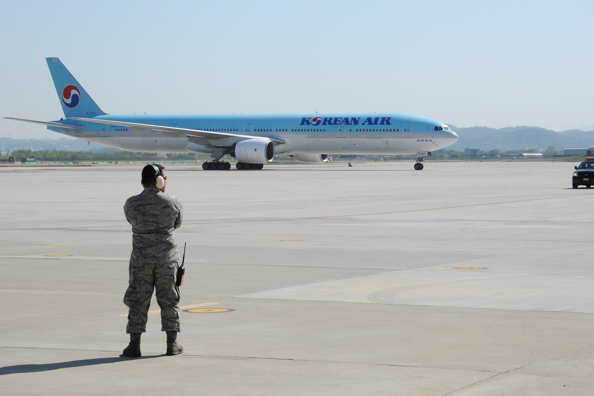 U.S. Air Force 1st Lt. Roed Mejia, 731st Air Mobility Squadron passenger services flight commander, prepares to direct an incoming Korean Air Boeing 777 aircraft during a Mutual Airlift Support Agreement (MASA) exercise at Osan Air Base, Republic of Korea, May 4, 2018. The MASA demonstrates the alliance between the United States and ROK, which enabled the 731st AMS to process passengers and load personnel baggage onto a Korean commercial aircraft. (U.S. Air Force photo by Tech. Sgt. Ashley Tyler)