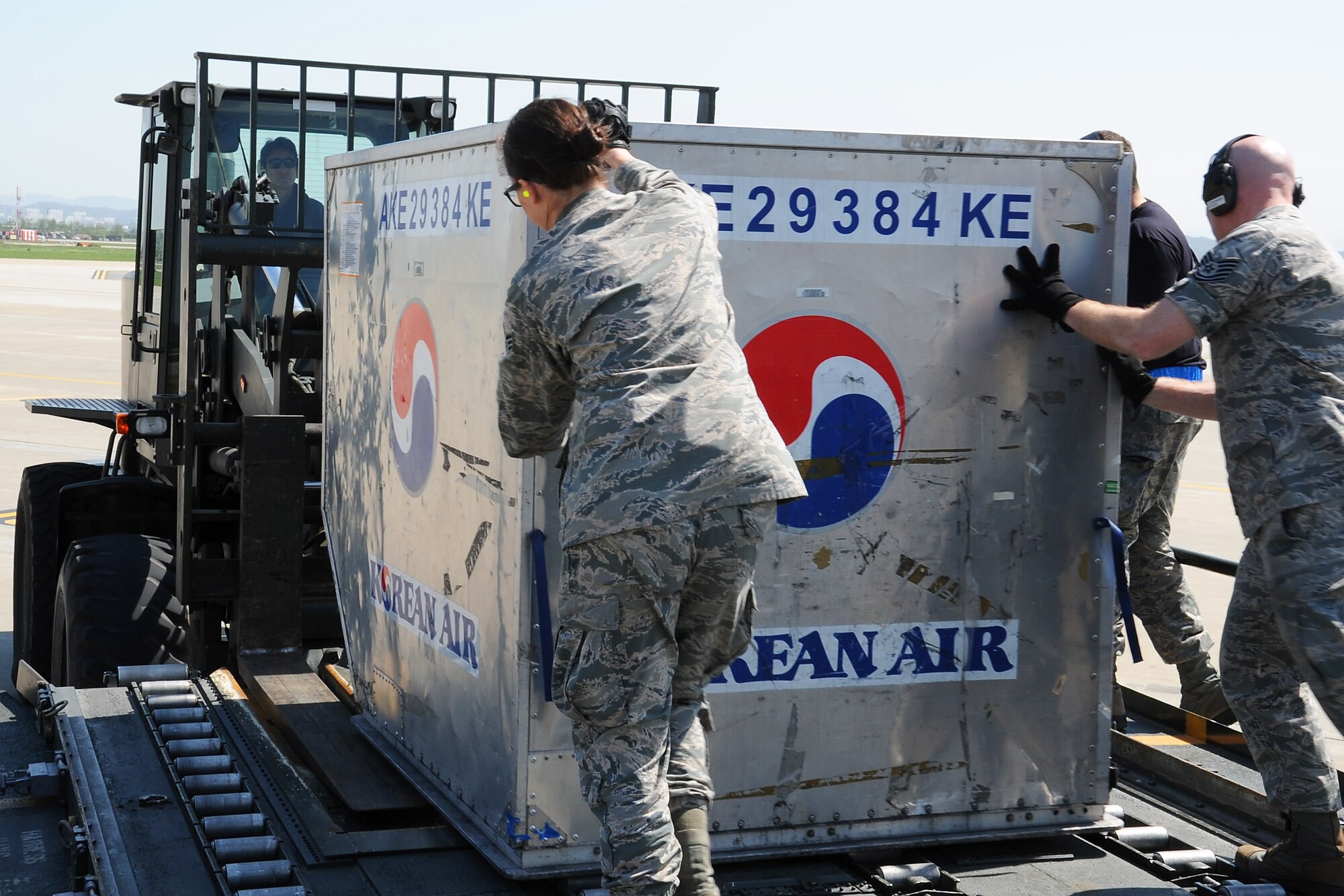 Personnel assigned to the 731st Air Mobility Squadron and 67th Aerial Port Squadron at Hill Air Force Base, Utah unload a Korean Air baggage container during the Mutual Airlift Support Agreement (MASA) exercise at Osan Air Base, Republic Of Korea May 4, 2018. The MASA demonstrates the alliance between the United States and ROK, which enabled the 731st AMS to process passengers and load personnel baggage onto a Korean commercial aircraft. (U.S. Air Force photo by Tech. Sgt. Ashley Tyler)