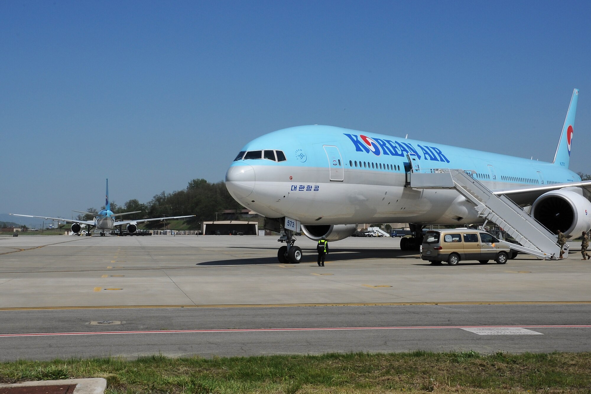 Two Korean Air Boeing 777 aircraft sit on the flightline during the Mutual Airlift Support Agreement (MASA) exercise at Osan Air Base, Republic of Korea May 4, 2018. Close coordination between U.S. Transportation Command at Scott Air Force Base, Illinois, the ROK Air Force, U.S. Forces Korea, Korean Air and the Osan Air Base team was required to accomplish the transport of more than 500 Soldiers to exercise Balikatan in the Philippines. (U.S. Air Force photo by Tech. Sgt. Ashley Tyler)