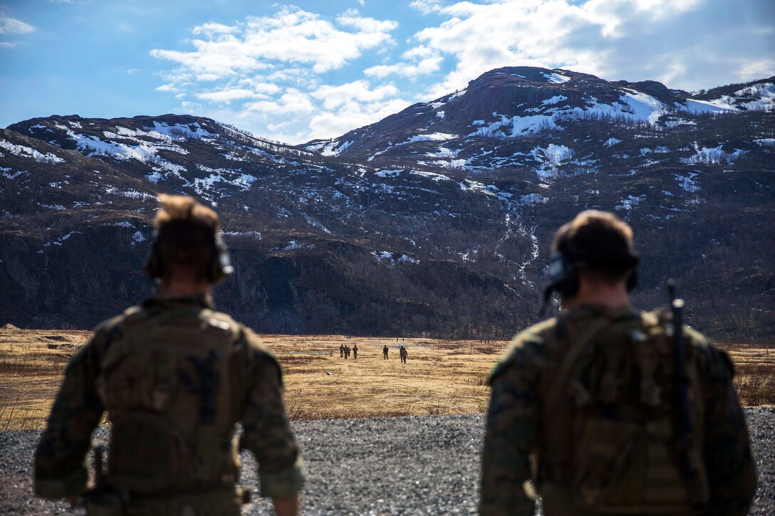 U.S. Marines, foreground, observe the Norwegian coastal ranger commandos conducting training.