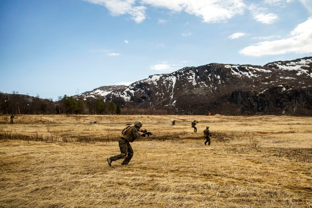 U.S. Marines receive simulated contact fire while conducting a live-fire.