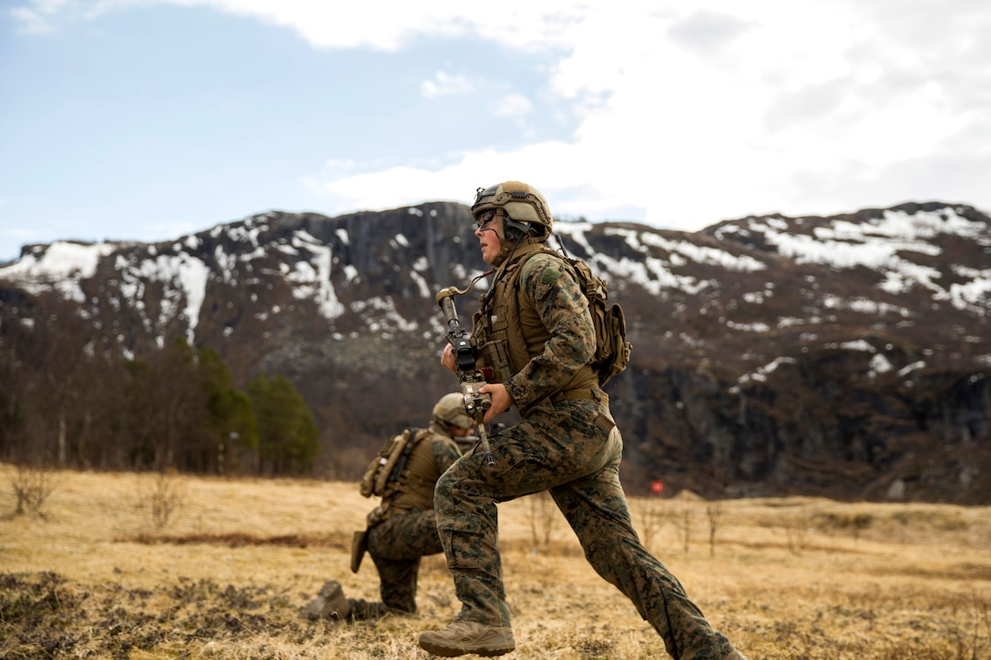 A Marine runs for cover while conducting a live-fire range.