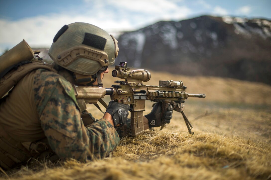 A Marine fires his weapon at targets while conducting a live-fire range.