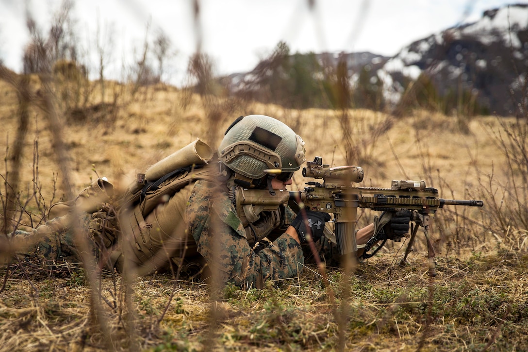 A Marine fires his weapon at targets while conducting a live-fire range.