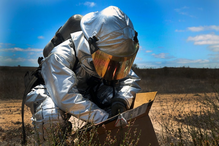 Lance Cpl. Luis Da Luz, a hazardous material entry team technician with Aircraft Rescue and Fire Fighting, passes HAZMAT samples to Lance Cpl. Alex Herrero, a HAZMAT entry team technician with ARFF, during an exercise at Marine Corps Air Station Miramar, Calif., May 17. The exercise simulated a bioterrorism attack and required several MCAS Miramar units to coordinate an effective response.
