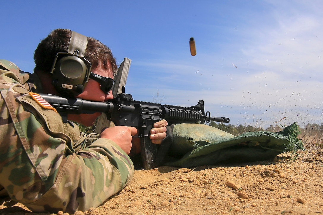 A soldier fires his M-4 Carbine at targets 100 meters away.