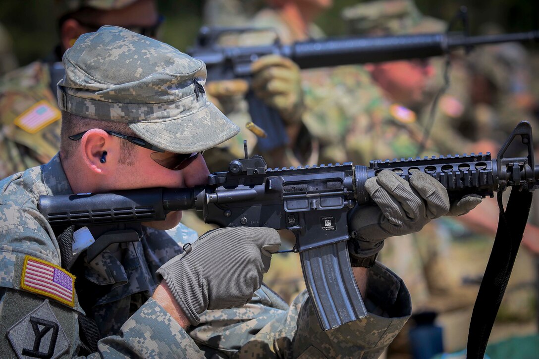 A soldier fires his M-4 Carbine at targets 100 meters away.