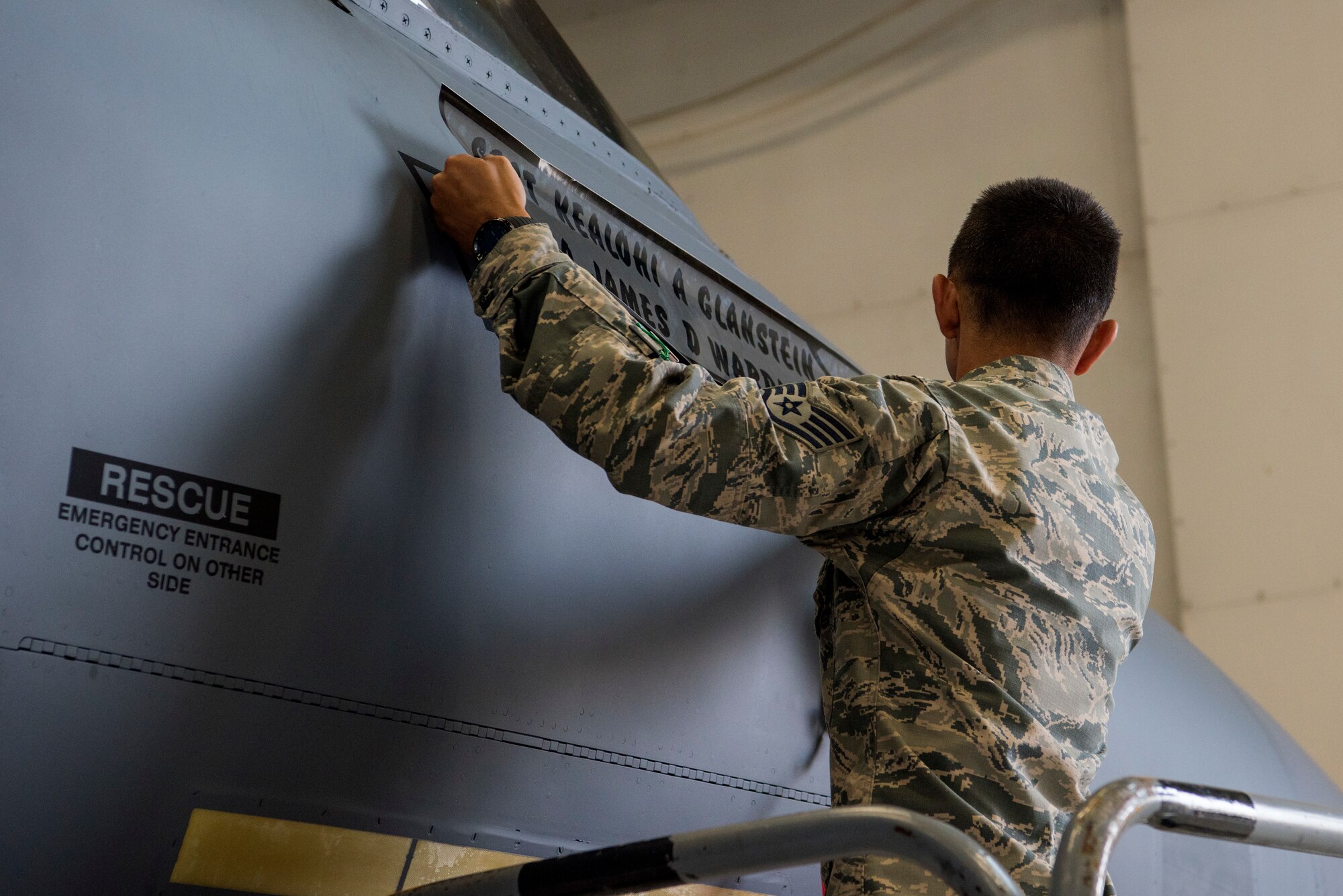 Staff Sgt. Kealohi Glanstein, 4th Aircraft Maintenance Squadron crew chief, reveals the new dedicated crew chief for the flagship aircraft of the 335th Fighter Squadron, May 18, 2018, at Seymour Johnson Air Force Base, North Carolina.