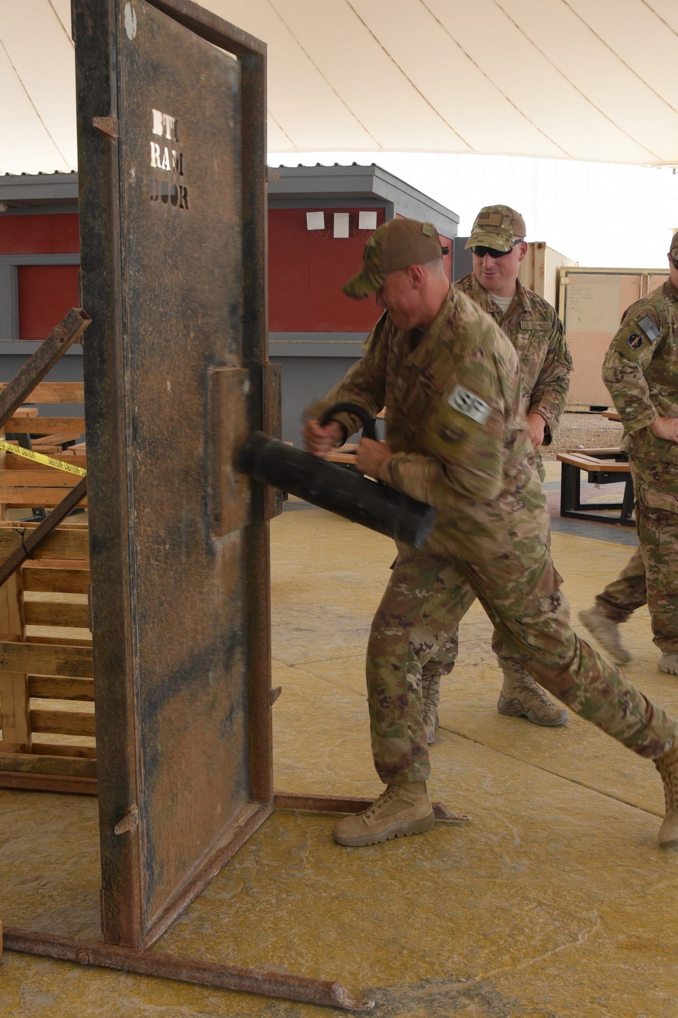 Members of the 379th Expeditionary Security Forces Squadron demonstrate room clearing procedures during National Police Week at Al Udeid Air Base, Qatar, May 16, 2018. Throughout the week, security forces members held numerous events to highlight capabilities and competencies of the squadron. (U.S. Air Force photo by Staff Sgt. Enjoli Saunders)