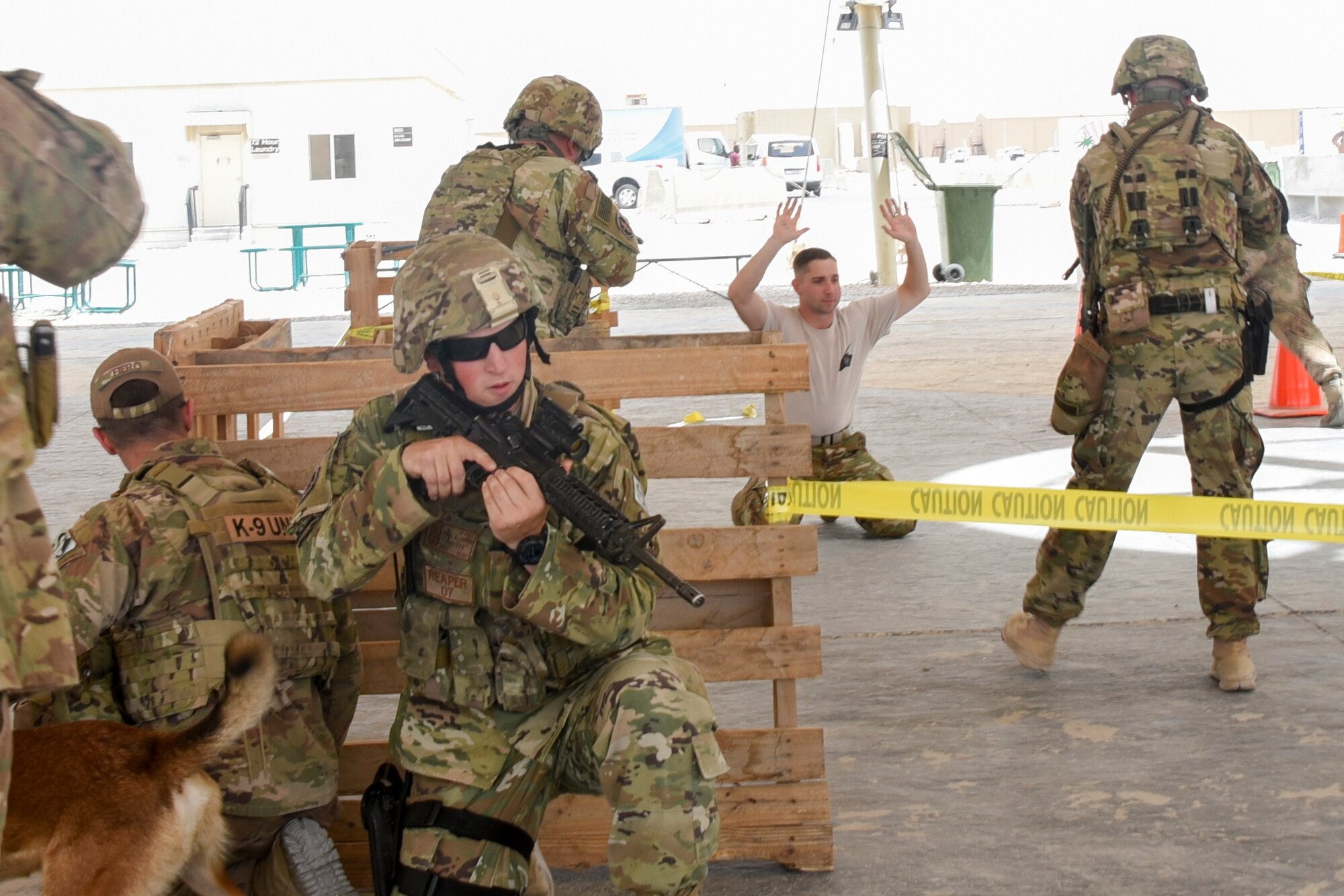 Members of the 379th Expeditionary Security Forces Squadron demonstrate room clearing procedures during National Police Week at Al Udeid Air Base, Qatar, May 16, 2018. Throughout the week, security forces members held numerous events to highlight capabilities and competencies of the squadron. (U.S. Air Force photo by Staff Sgt. Enjoli Saunders)