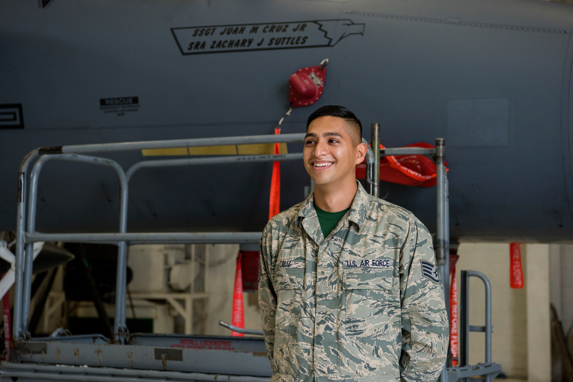 Staff Sgt. Juan Cruz Jr., 4th Aircraft Maintenance Squadron dedicated crew chief, stands in front of his recently revealed name on an F-15E Strike Eagle, May 18, 2018, at Seymour Johnson Air Force Base, North Carolina.