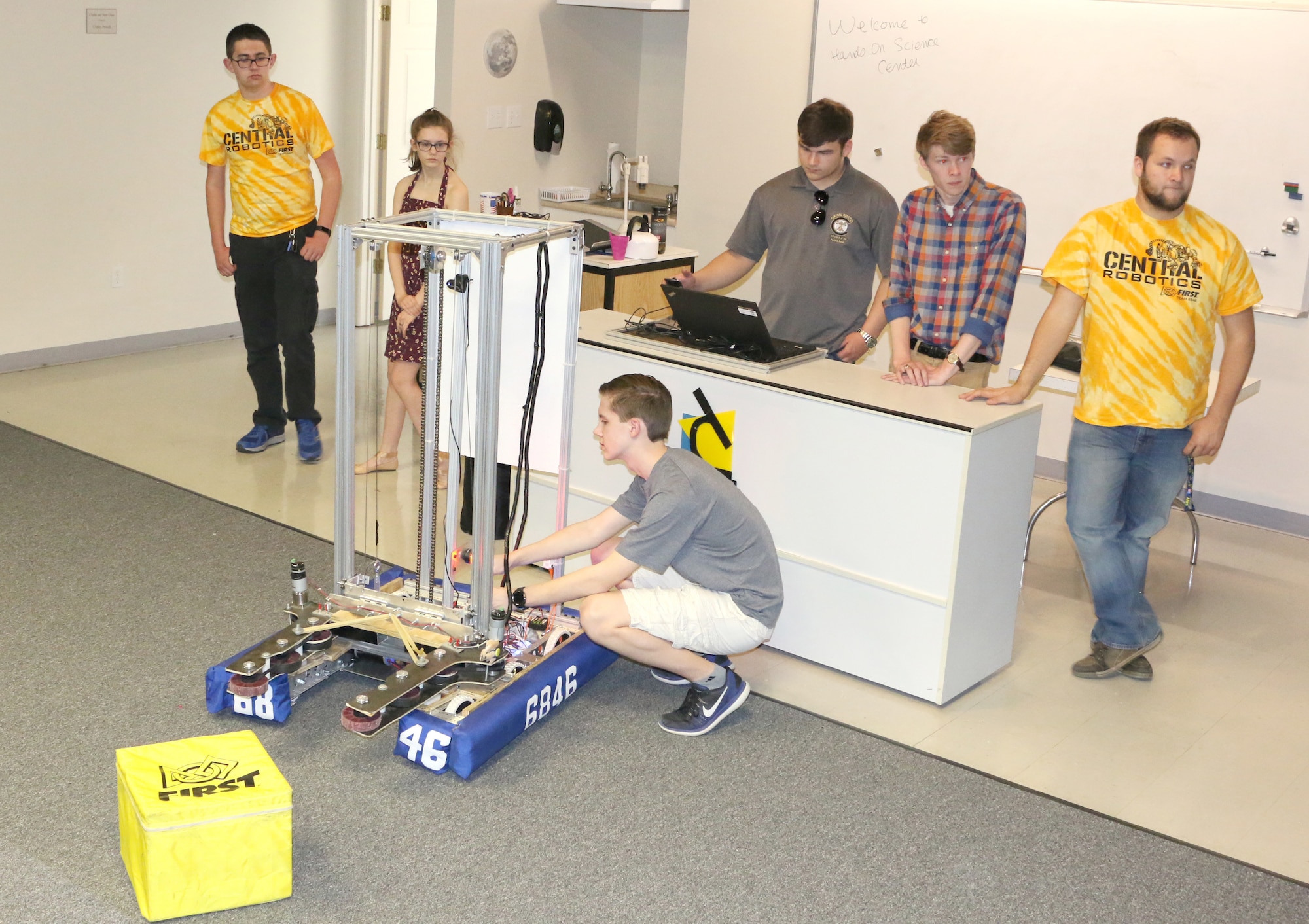 Central Magnet Robotics team member David Schafer adjusts the robot during the team’s demonstration at the Hands-On Science Center in Tullahoma May 1. Pictured in back, from left to right, are Ethan Davenport, Maddy Perrien, Jimmy Jones, Drew Dove and Aidan Gibson. (U.S. Air Force photo/Deidre Ortiz)
