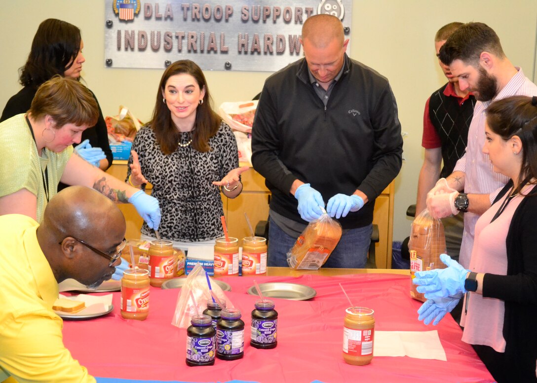 Mentors and mentees join together to make sandwiches as part of "blessing bags" for the homeless in Philadelphia on May 17.