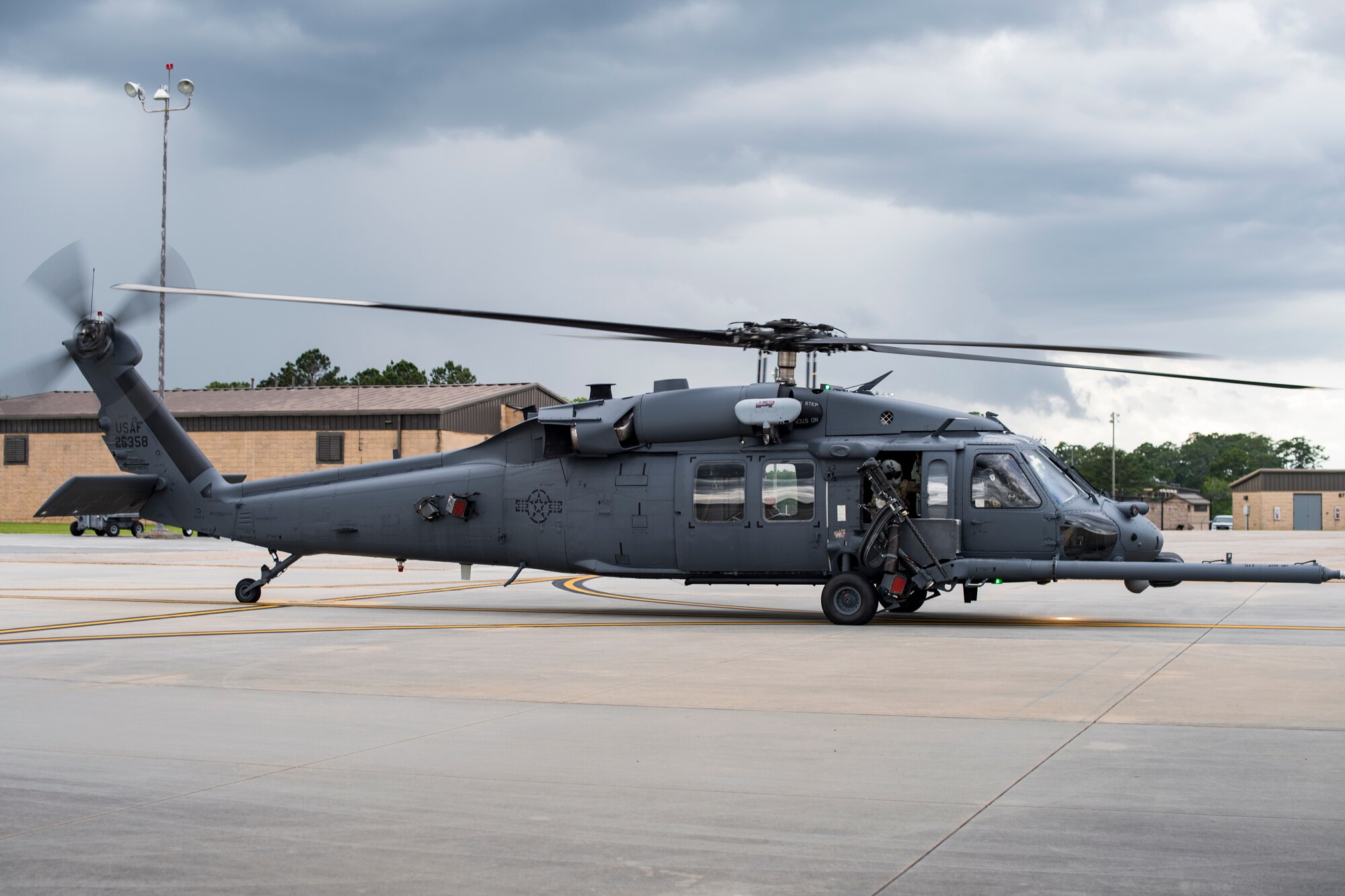 A special missions aviator from the 41st Rescue Squadron looks out the window of an HH-60G Pave Hawk while taxing on the flightline, May 17, 2018, at Moody Air Force Base, Ga. Airmen conduct routine training missions in the airspace surrounding Moody to remain current on their tactics and procedures. While helping pilots remain proficient, training also gives crew chiefs and maintainers the opportunity to remain proficient at launching and maintaining the aircraft. (U.S. Air Force photo by Senior Airman Janiqua P. Robinson)