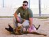 Staff Sgt. Connor Patron, 386th Expeditionary Security Forces Squadron military working dog handler, poses with his partner, Xxue, MWD, at an undisclosed location in Southwest Asia, May 18, 2018. Patron and Xxue train for a variety of scenarios in support of Operation Inherent Resolve. (U.S. Air Force photo by Senior Airman Michala Weller)