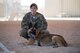 Senior Airman Nicole Meyer, 386th Expeditionary Security Forces Squadron military working dog handler, relaxes with her dog, Nido, during a K-9 demo at an undisclosed location in Southwest Asia, May 18, 2018. The K-9 demo was one of 12 events throughout police week. (U.S. Air Force photo by Staff Sgt. Joshua King)