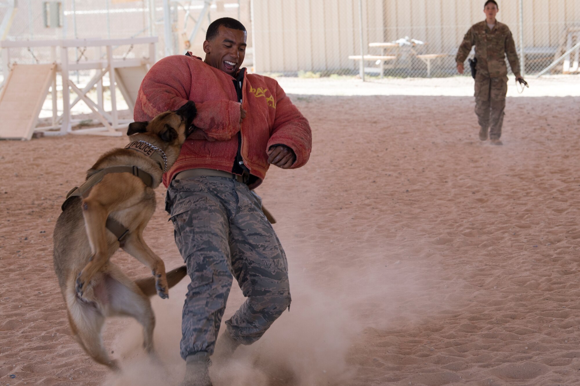 Staff Sgt. Dante Tost, 386th Expeditionary Security Forces Squadron military working dog handler, does bite drills with Nido, a military working dog, at an undisclosed location in Southwest Asia, May 18, 2018. The military working dog team showed their skills during a K-9 demo that was during police week. (U.S. Air Force photo by Staff Sgt. Joshua King)