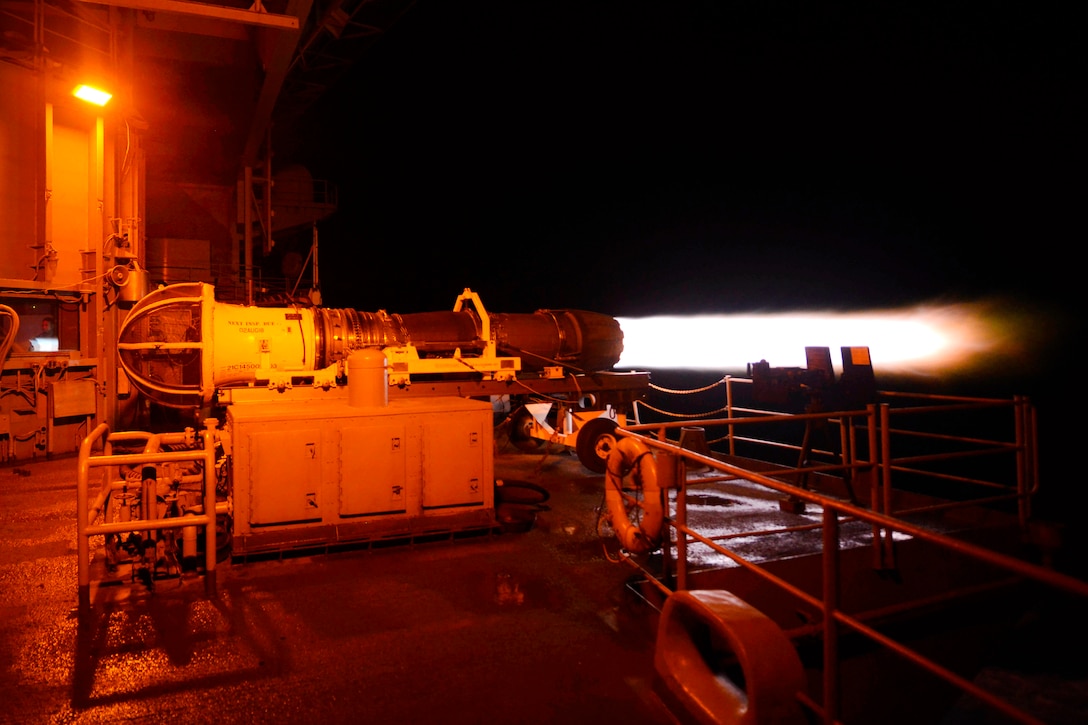 Sailors test a jet engine on the fantail of the aircraft carrier USS Harry S. Truman.