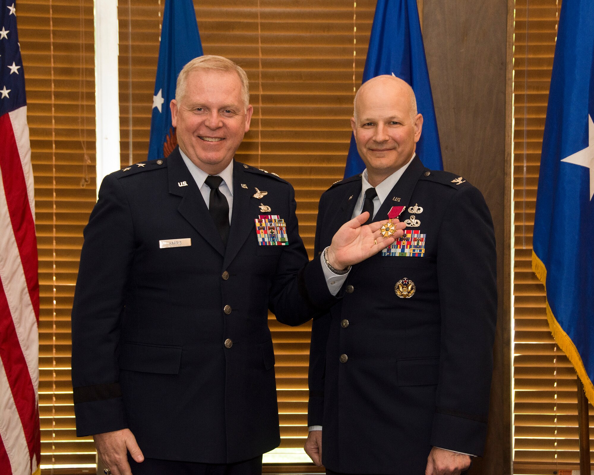 During a retirement ceremony held for Col. Raymond Briggs, right, May 11 at Arnold Lakeside Center, Maj. Gen. David Harris, left, Air Force Test Center commander, pins the Legion of Merit medal onto Briggs’ lapel. The Legion of Merit is an award given for exceptionally meritorious conduct in the performance of outstanding services and achievements. Briggs is retiring this month from his position as chief of the Test System Sustainment Division at Arnold Engineering Development Complex. (U.S. Air Force photo/Rick Goodfriend)