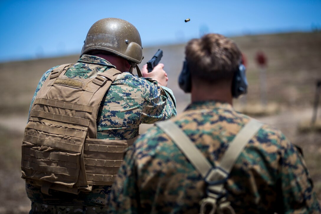 Gunnery Sgt. Zachary Holm, operations chief, Echo Company, 4th Reconnaissance Battalion, fires a M1911 pistol during the marksmanship portion of the 10th Annual Recon Challenge on Marine Corps Base Camp Pendleton, Calif., May 17, 2018. Participants are expected to clear various checkpoints of basic reconnaissance related skills during the event. (U.S. Marine Corps photo by Cpl. Juan C. Bustos)