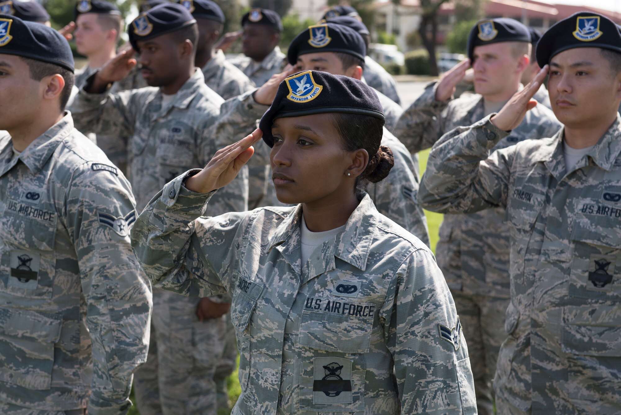 Airman 1st Class Zoey Sacre, 821st Contingency Response Squadron, salutes the U.S. flag during a retreat ceremony to close out Police Week May 18, 2018 at Travis Air Force Base, Calif. The ceremony featured a roll call for 27 fallen Airmen, the playing of Taps and the ceremonious folding of the American flag. (U.S. Air Force photo by Tech. Sgt. James Hodgman)