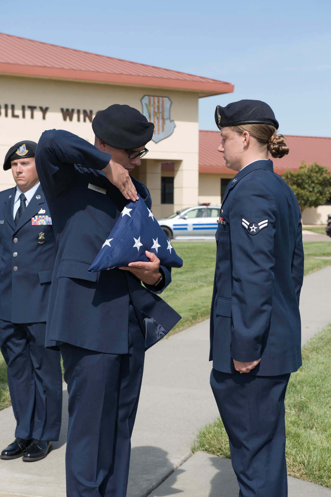 Senior Airman Robert Aube, 60th Security Forces Squadron installation patrolman, folds the American flag during a retreat ceremony to close out Police Week May 18, 2018 at Travis Air Force Base, Calif. The ceremony featured a roll call for 27 fallen Airmen, the playing of Taps and the ceremonious folding of the American flag. (U.S. Air Force photo by Tech. Sgt. James Hodgman)