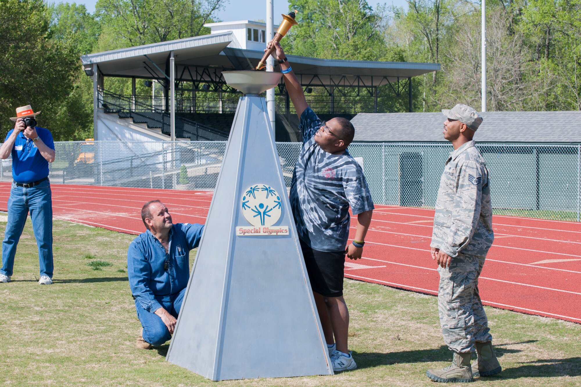 Arnold Air Force Base Staff Sgt. Richard Griffin participates in the lighting of the Special Olympics torch with athlete Darius Battles at the Area 13 Special Olympics on May 1 at the Tullahoma High School stadium. (U.S. Air Force photos/Jacqueline Cowan)