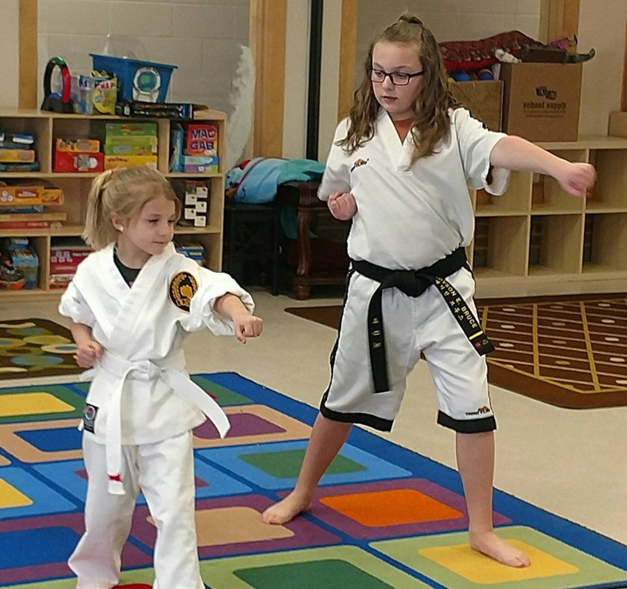 Madyson (on the right) teaches the beginners class, and she is instructing one of her students on martial arts moves. (Courtesy photo)