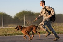Staff Sgt. Jeffery Hill, 902nd Security Forces Squadron military working dog handler, and his dog Ccharles, run the 1-mile ruck march May 17 on Joint Base San Antonio-Randolph, Texas in honor of Police Week. Police Week is a week-long event that pays tribute to the time, service and sacrifice of law enforcement officers nationwide. (U.S. Air Force photo by Airman Shelby Pruitt)