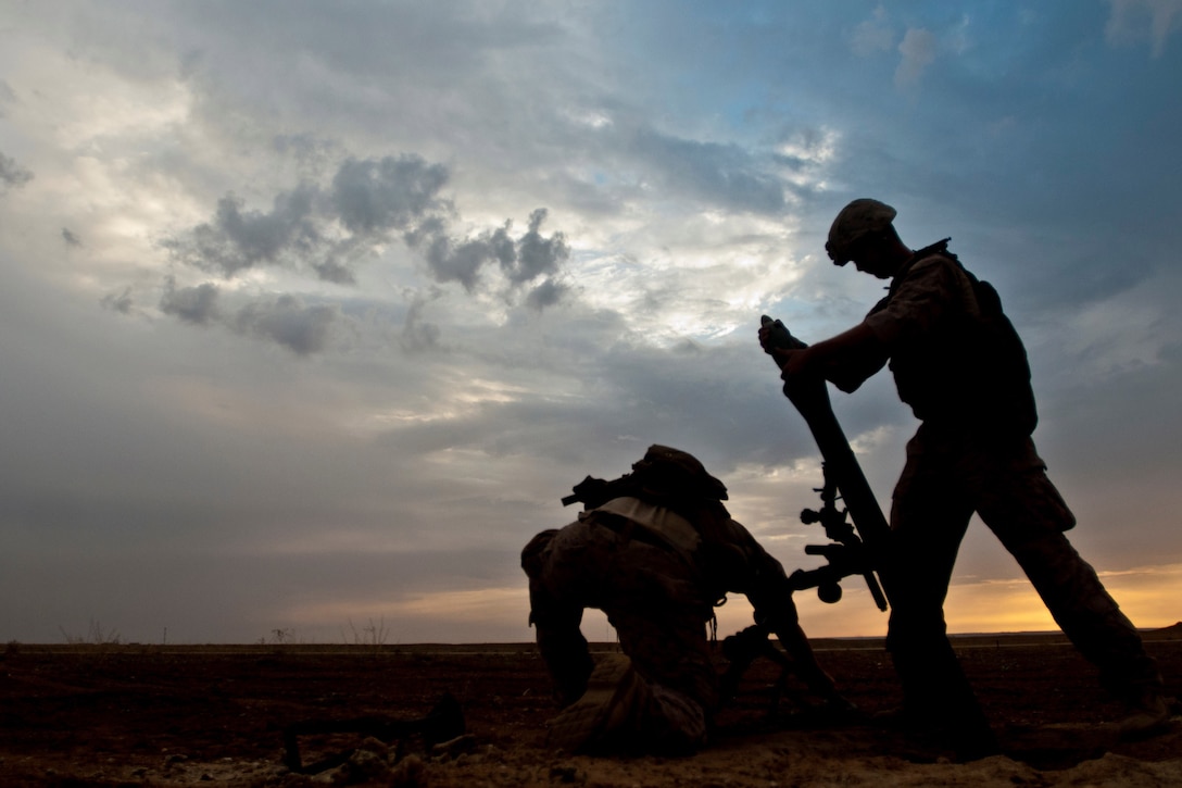 Coalition forces prepare to fire a mortar during military operations near the Iraq-Syria border.