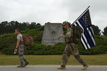 U.S. Air Force Airman 1st Class Christopher Rippin, 20th Security Forces Squadron (SFS) installation entry controller, left, and Tech. Sgt. Justin Bell, 20th SFS standards and evaluation technician, participate in a National Police Week March for the Fallen at Shaw Air Force Base, S.C., May 17, 2018.