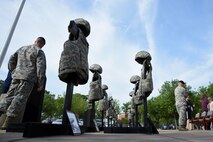 Team Shaw members gather around a fallen Airmen memorial prior to a National Police Week opening ceremony at Shaw Air Force Base, S.C., May 14, 2018.