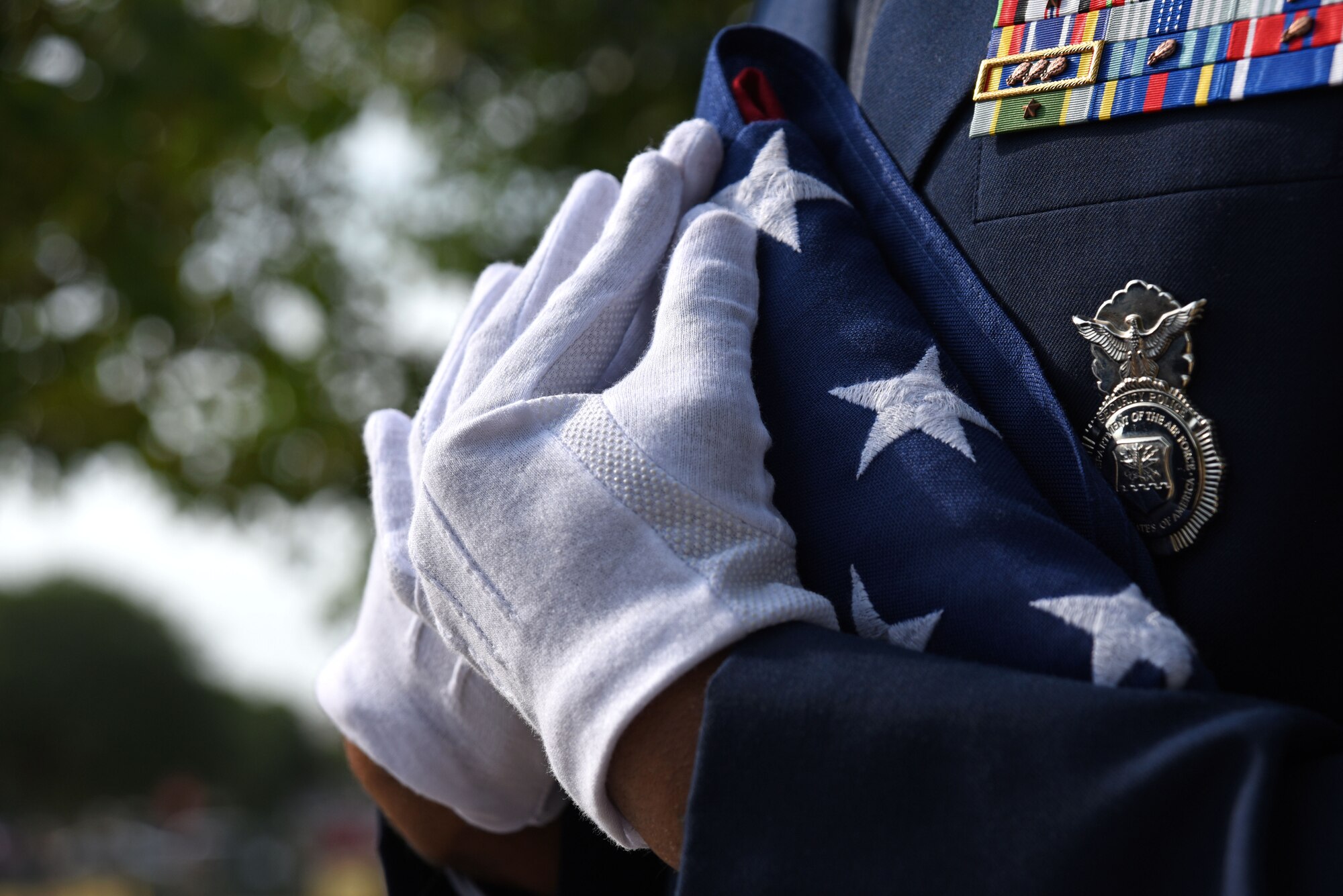 U.S. Air Force Tech. Sgt. Derek Smiling, 20th Security Force Squadron flight sergeant, holds a U.S. flag prior to a National Police Week opening ceremony at Shaw Air Force Base, S.C., May 14, 2018.