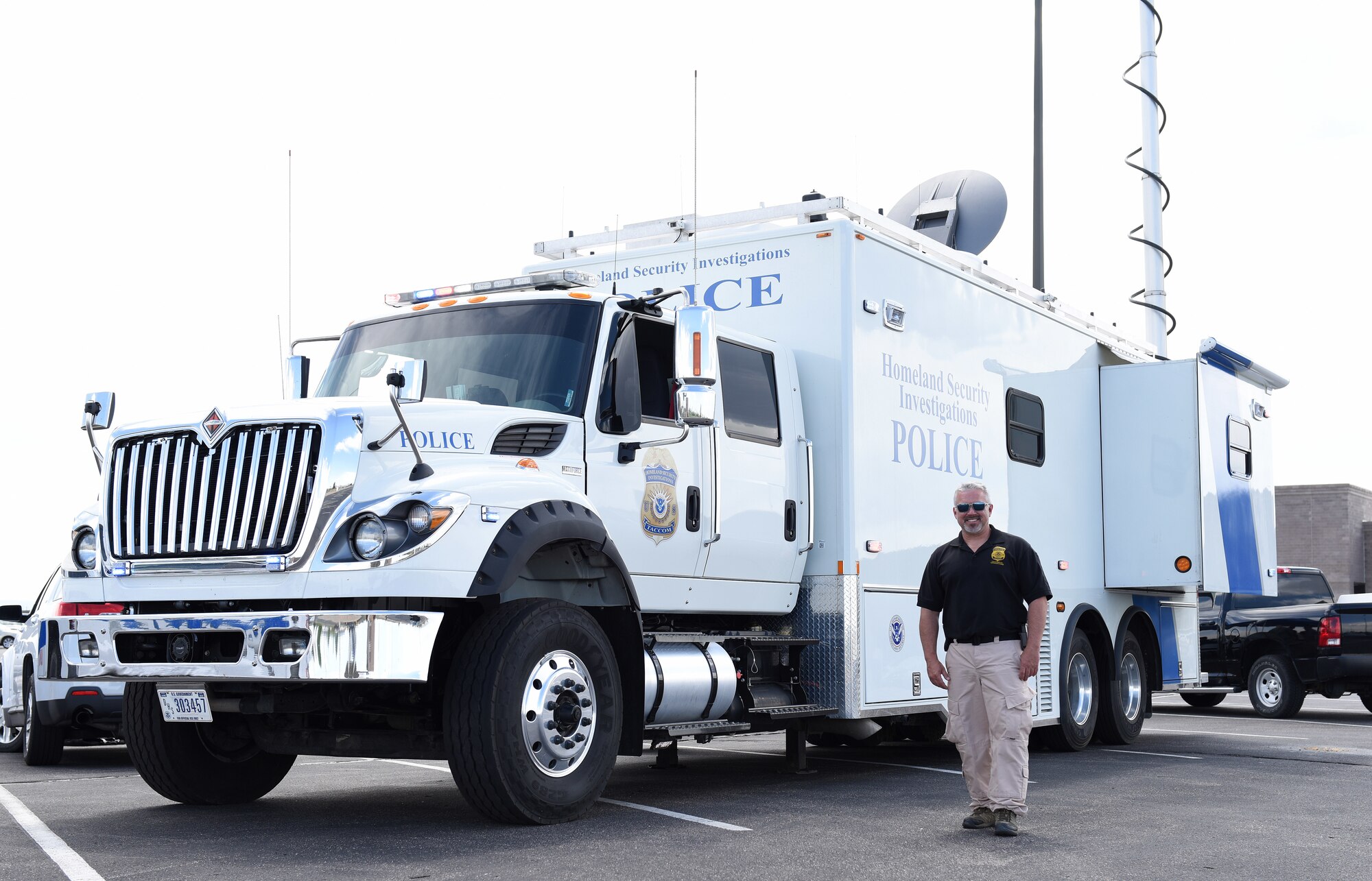 Jason Powers, U.S. Department of Homeland Security technical law enforcement officer, poses in front of a mobile command center vehicle during a Police Week demonstration at Buckley Air Force Base, Colorado, May 17, 2018.