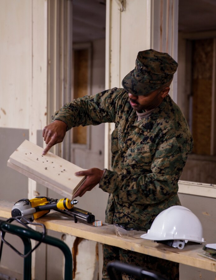 U.S. Navy Petty Officer 1st Class Brandon D. Flake, hospital corpsman with Engineer Support Company, 6th Engineer Support Battalion, 4th Marine Logistics Group, shows the Marines with 6th ESB, 4th MLG, and the British commando’s with 131 Commando Squadron Royal Engineers, British Army, the damage a nail gun could cause if it is not used with caution at a construction site during exercise Red Dagger at Fort Indiantown Gap, Pa., May 19, 2018. Exercise Red Dagger is a bilateral training exercise that gives Marines an opportunity to exchange tactics, techniques and procedures as well as build working relationships with their British counterparts. (U.S. Marine Corps photo by Sgt. Melanie Wolf/Released)