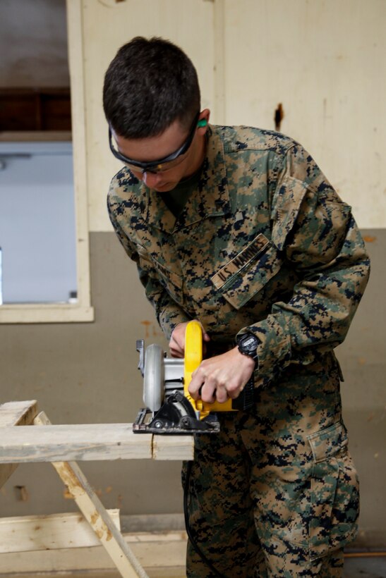 U.S. Marine Lance Cpl. Cody A. Evans, combat engineer with Engineer Company C, 6th Engineer Support Battalion, 4th Marine Logistics Group, practices using a circular saw power tool at a construction site during exercise Red Dagger at Fort Indiantown Gap, Pa., May 19, 2018.