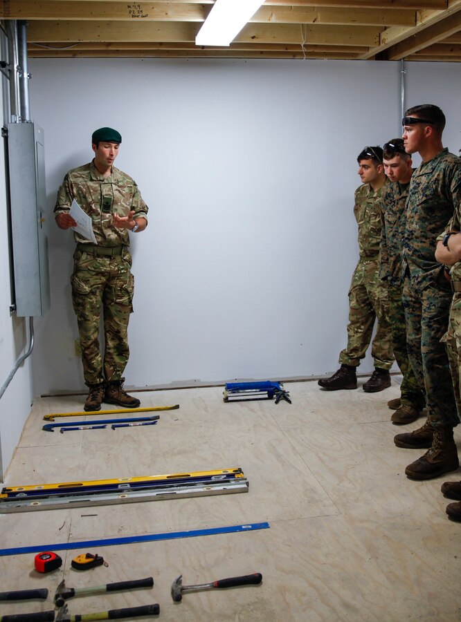 British Army SSgt. Callum M. Crowe, commando with 131 Commando Squadron Royal Engineers, British Army, shows Marines with 6th Engineer Support Battalion, 4th Marine Logistics Group, and British commando’s with 131 Commando Squadron RE, British Army, the tools they will be using at a construction site during exercise Red Dagger at Fort Indiantown Gap, Pa., May 19, 2018. Exercise Red Dagger is a bilateral training exercise that gives Marines an opportunity to exchange tactics, techniques and procedures as well as build working relationships with their British counterparts. (U.S. Marine Corps photo by Sgt. Melanie Wolf/Released)
