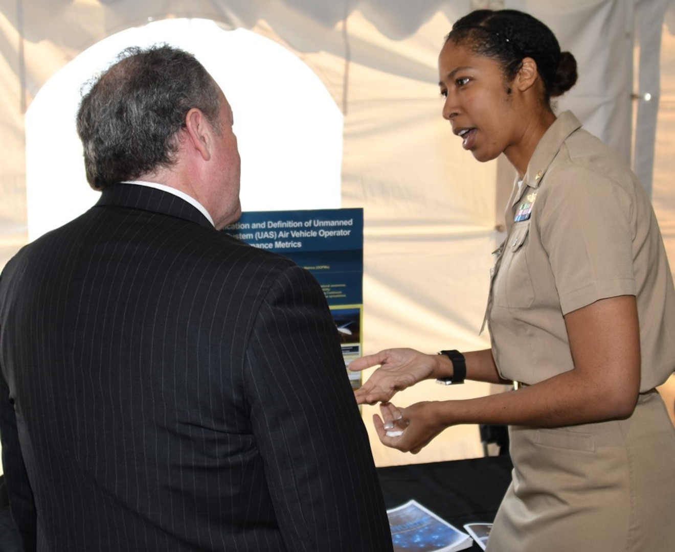 IMAGE: DAHLGREN, Va. (May 2, 2018) - Lt. Cmdr. Rolanda Findlay presents her technological project - Identification and Definition of Unmanned Aerial System Air Vehicle Operator Performance Metrics - at the two-day 2018 Naval Innovative Science and Engineering (NISE) Technical Exchange Meeting held at Naval Surface Warfare Center Dahlgren Division. More than 150 NISE-funded innovations, including Findlay's project, were presented to the Department of Defense technical leaders, scientists, and engineers who visited the Deputy Assistant Secretary of Defense for Research, Development, Test and Evaluation sponsored event to see and learn about the NISE projects and their alignment to naval systems and naval needs. (U.S. Navy photo/Released)