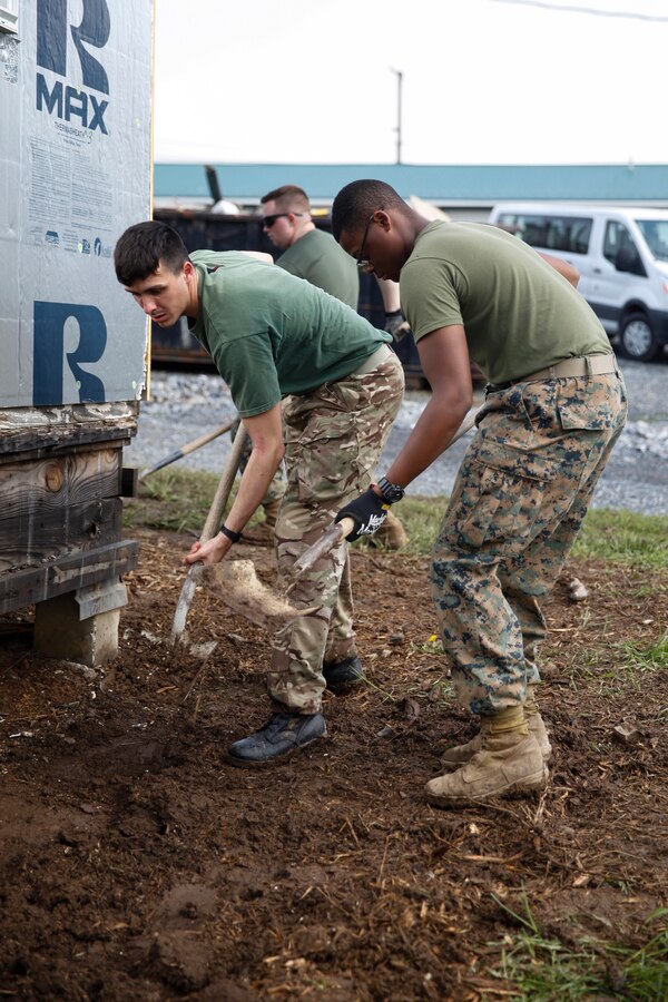 British Army Spr. Adam Foreman, commando with 131 Commando Squadron Royal Engineers, British Army and U.S. Marine Lance Cpl. Jerricko L. Willins, combat engineer with Bridge Company C, 6th Engineer Support Battalion, 4th Marine Logistics Group, level dirt with shovels at a construction site during exercise Red Dagger at Fort Indiantown Gap, Pa., May 20, 2018. Exercise Red Dagger is a bilateral training exercise that gives Marines an opportunity to exchange tactics, techniques and procedures as well as build working relationships with their British counterparts. (U.S. Marine Corps photo by Sgt. Melanie Wolf/Released)