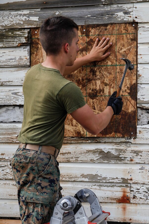 U.S. Marine Lance Cpl. Joshua M. Rowbutton, combat engineer with Bridge Company C, 6th Engineer Support Battalion, 4th Marine Logistics Group, hammers a nail into a piece of plywood at a construction site during exercise Red Dagger at Fort Indiantown Gap, Pa., May 20, 2018. Exercise Red Dagger is a bilateral training exercise that gives Marines an opportunity to exchange tactics, techniques and procedures as well as build working relationships with their British counterparts. (U.S. Marine Corps photo by Sgt. Melanie Wolf/Released)