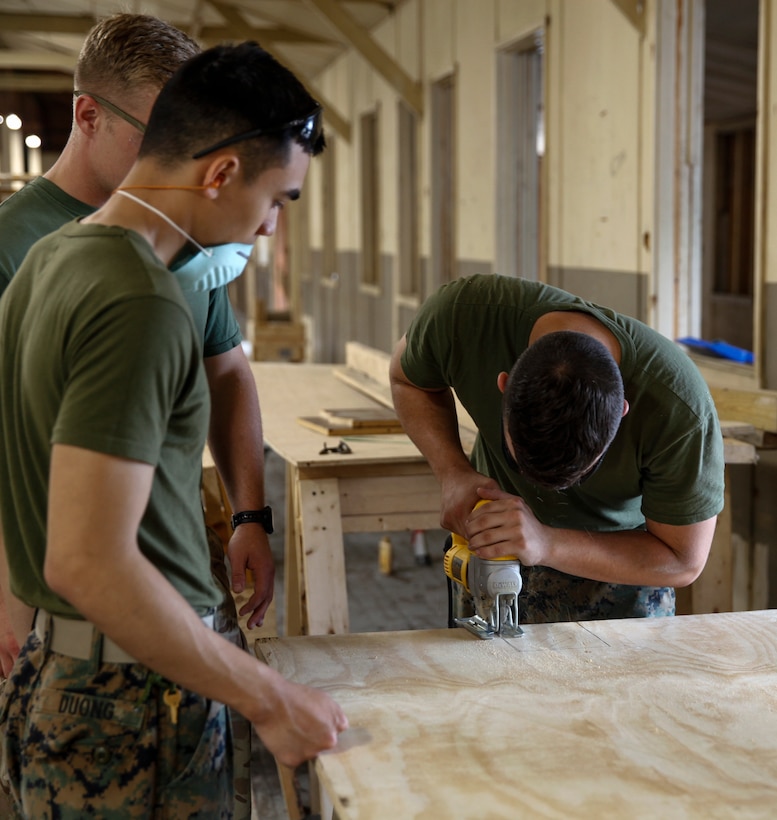 U.S. Marine Lance Cpl. Jacob N. Wooldridge, combat engineer with Bridge Company C, 6th Engineer Support Battalion, 4th Marine Logistics Group, uses a jig saw to cut a piece of plywood at a construction site during exercise Red Dagger at Fort Indiantown Gap, Pa., May 20, 2018.