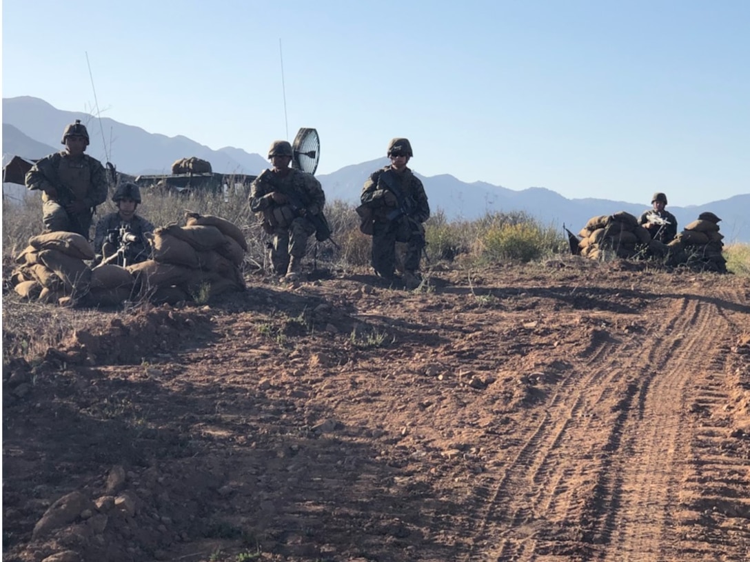 Marines of Transmissions Platoon, Company A provide security while establishing multichannel radio links.