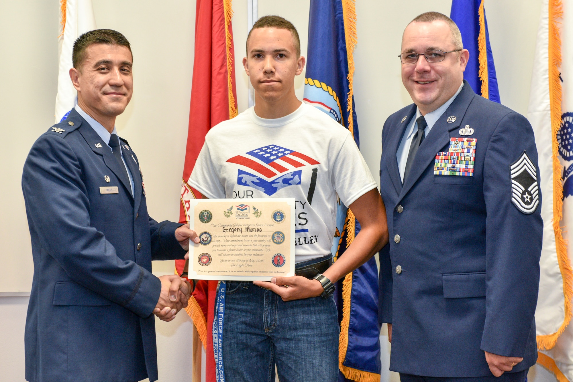 U.S. Air Force Col. Ricky Mills, 17th Training Wing commander, Lakeview graduate Marcos Gregory and Chief Master Sgt. Daniel Stein,  17th Training Wing command chief, pose during the Our Community Salutes ceremony in San Angelo, Texas, May 19, 2018. Gregory was the only enlistee for the Air Force of the 23 participants. (U.S. Air Force photo by Senior Airman Randall Moose/Released)
