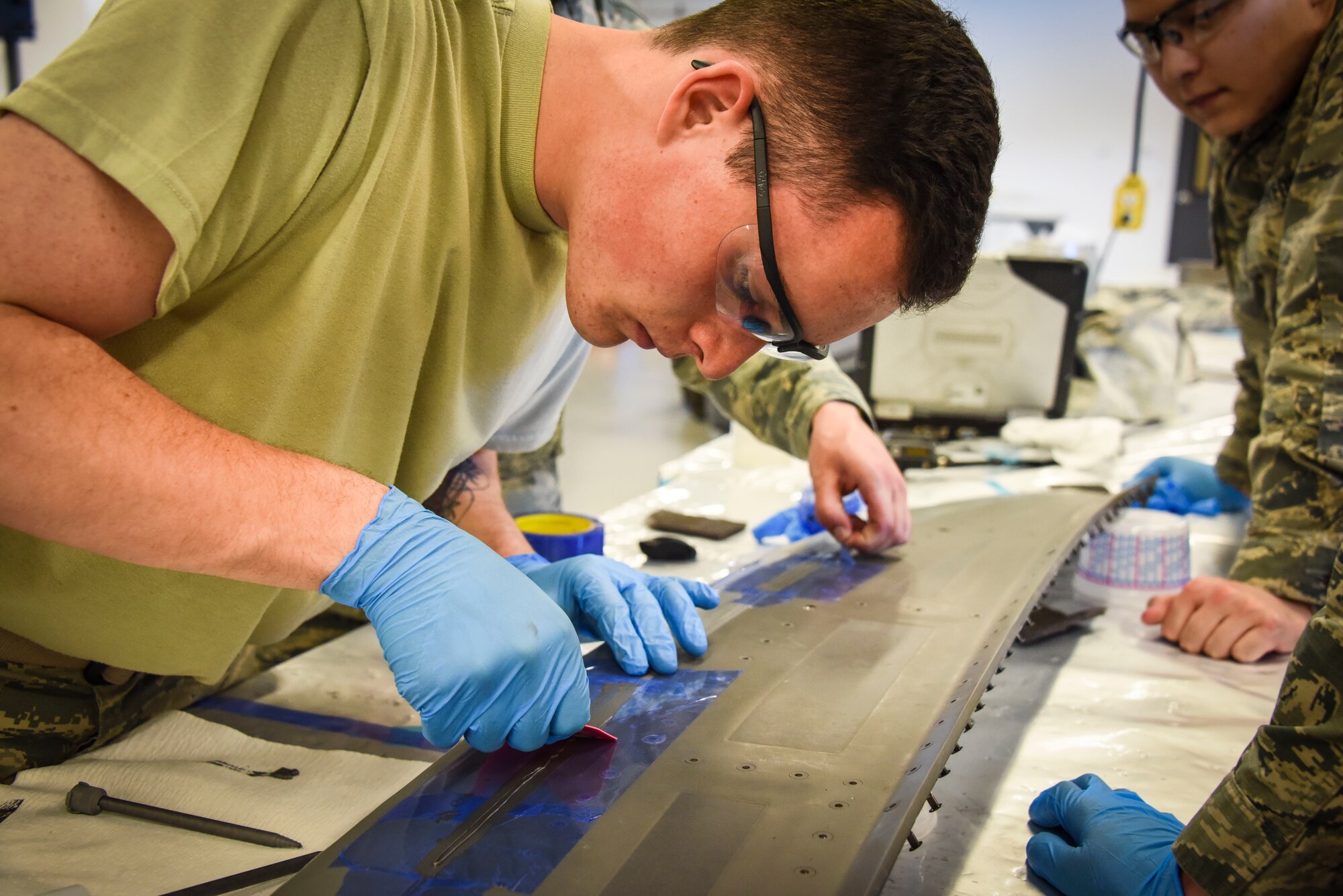 Airman 1st Class Wyatt Harrison applies coating on an F-35 Lightning II panel